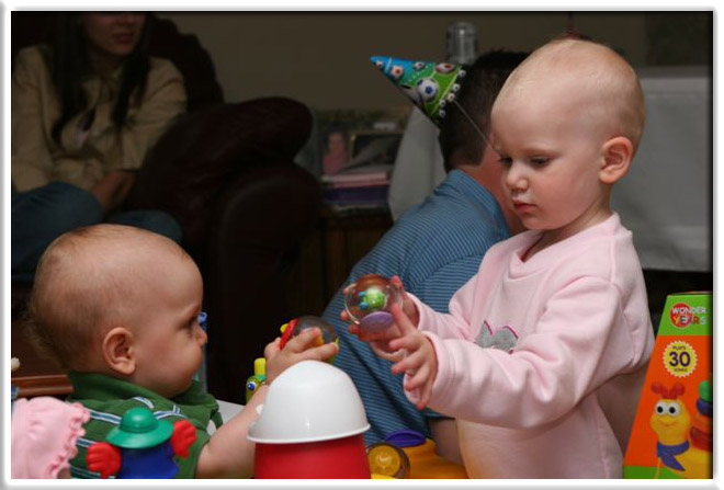 Will's cousin Olivia was helping him play with the new toys.
